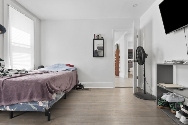 bedroom featuring baseboards and hardwood / wood-style floors