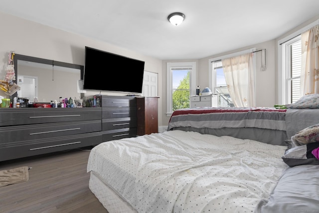 bedroom with dark wood finished floors