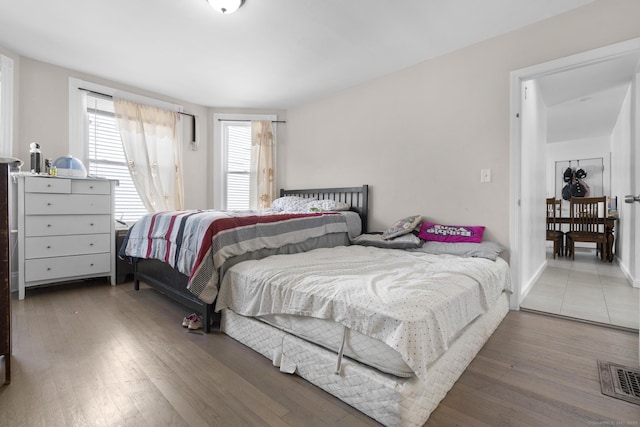 bedroom featuring visible vents and wood finished floors