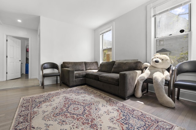 living room with recessed lighting, baseboards, and wood finished floors