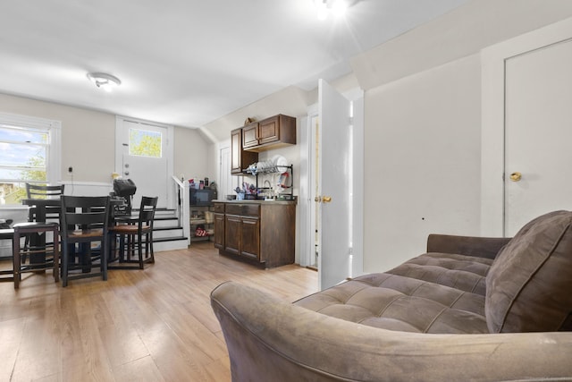 living room with lofted ceiling and light wood finished floors