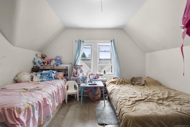 bedroom featuring lofted ceiling and wood finished floors