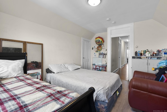 bedroom featuring vaulted ceiling and dark wood finished floors