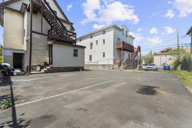 uncovered parking lot featuring fence