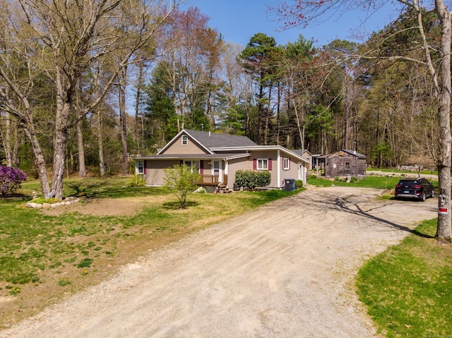 ranch-style house featuring driveway and a front yard