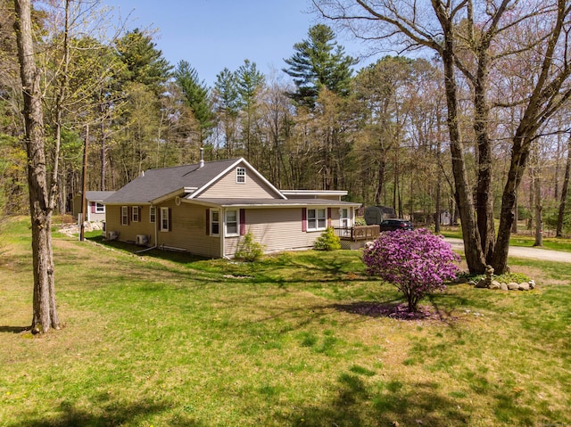 view of front of property with a wooden deck and a front yard