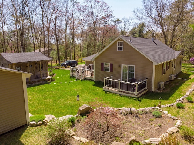 back of house featuring a lawn, central air condition unit, and a deck