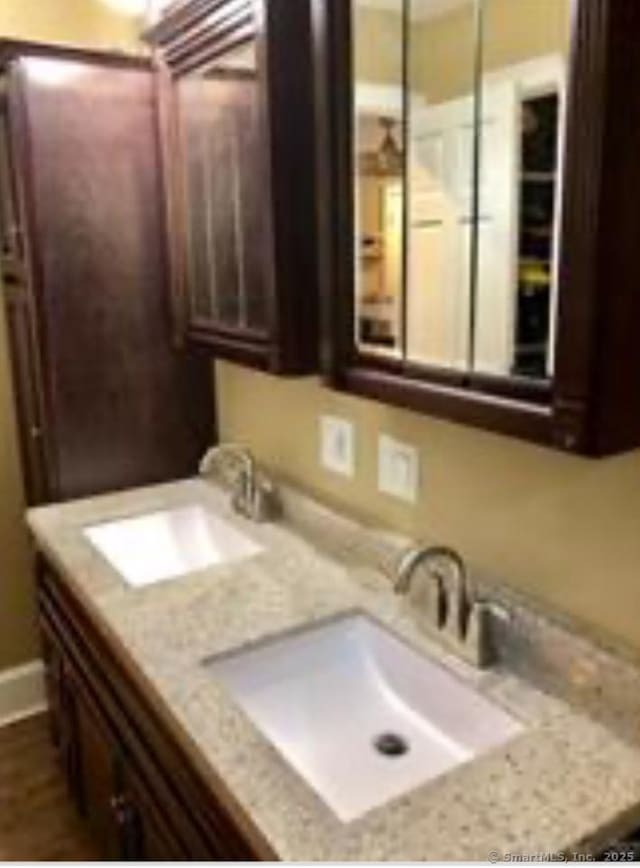 bathroom featuring double vanity and a sink