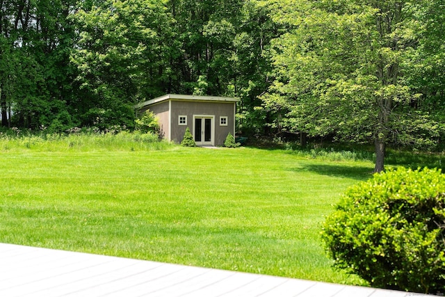 53 Upland Meadow Rd, Salisbury, CT 06068 - view of grassy yard featuring french doors, an outdoor structure, and a forest view