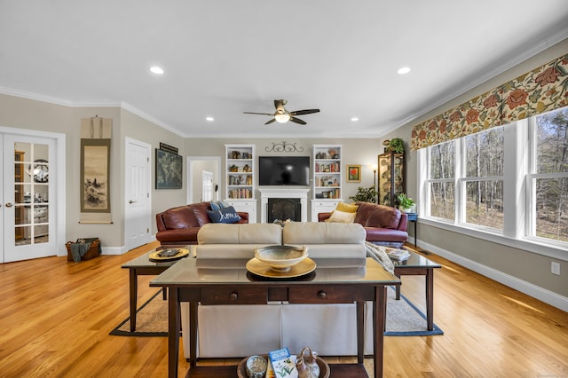 living area with ornamental molding, light wood-type flooring, a ceiling fan, and recessed lighting