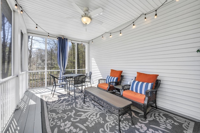 sunroom / solarium with a ceiling fan