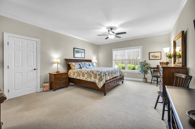 carpeted bedroom with a ceiling fan, baseboards, and ornamental molding