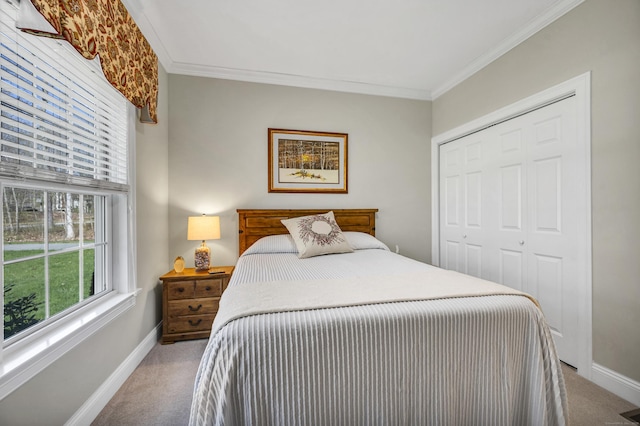 bedroom with carpet floors, baseboards, and a closet