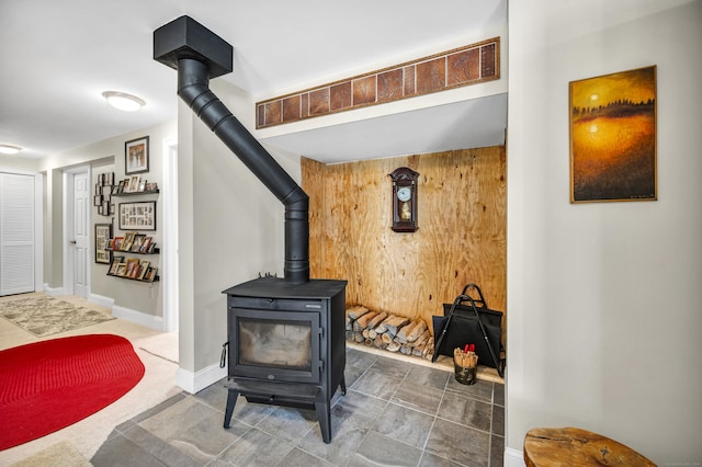 room details with baseboards and a wood stove