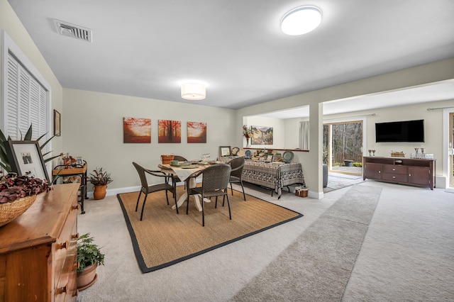 dining room with carpet flooring, baseboards, and visible vents