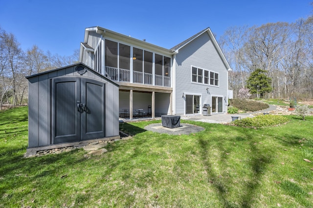 rear view of property featuring a storage shed, a lawn, an outdoor structure, and a patio area