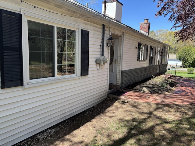 view of side of home featuring a chimney