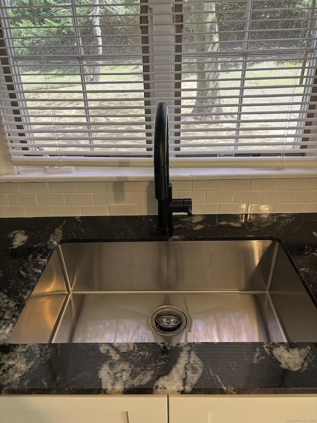 69 Bassett Rd, North Haven, CT 06473 - room details with a sink, backsplash, and dark stone countertops