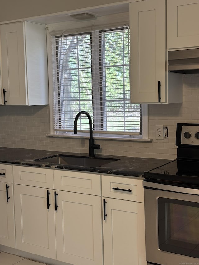 69 Bassett Rd, North Haven, CT 06473 - kitchen featuring stainless steel electric stove, decorative backsplash, under cabinet range hood, and white cabinetry