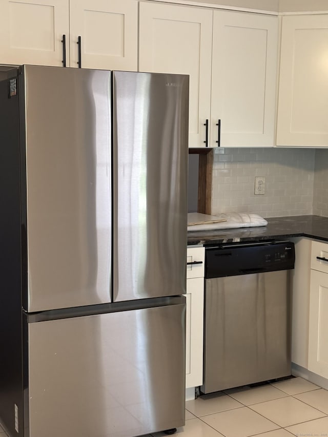 69 Bassett Rd, North Haven, CT 06473 - kitchen featuring white cabinetry, light tile patterned floors, tasteful backsplash, and stainless steel appliances