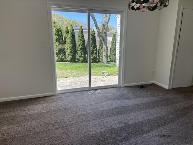carpeted empty room with baseboards and visible vents
