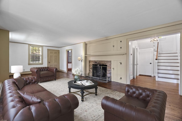 212 Main St N, Woodbury, CT 06798 - living area with wood finished floors, stairs, a fireplace, and baseboards
