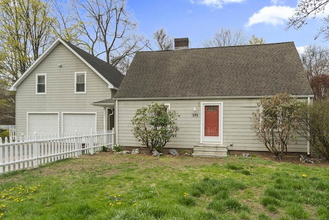 cape cod home with a chimney, a front yard, fence, an attached garage, and entry steps
