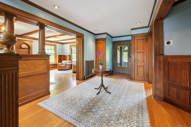 836 Prospect Ave, Hartford, CT 06105 - entrance foyer featuring crown molding, light wood finished floors, wainscoting, and decorative columns