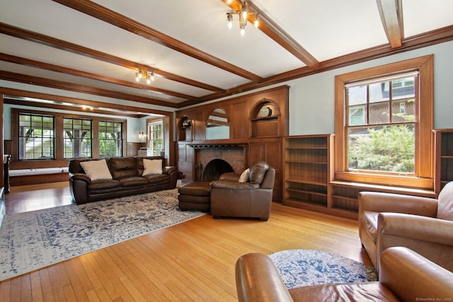 836 Prospect Ave, Hartford, CT 06105 - living area with beamed ceiling, a fireplace, and light wood finished floors