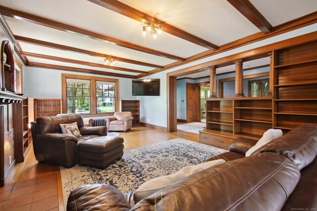 836 Prospect Ave, Hartford, CT 06105 - living room with beamed ceiling, crown molding, wood finished floors, baseboards, and decorative columns