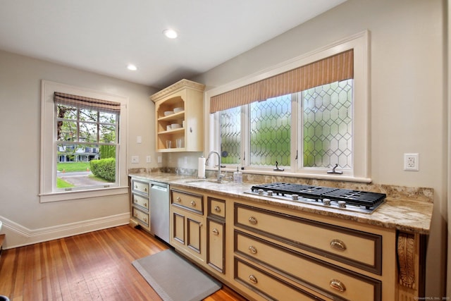 836 Prospect Ave, Hartford, CT 06105 - kitchen with stainless steel appliances, a sink, light wood-type flooring, baseboards, and open shelves