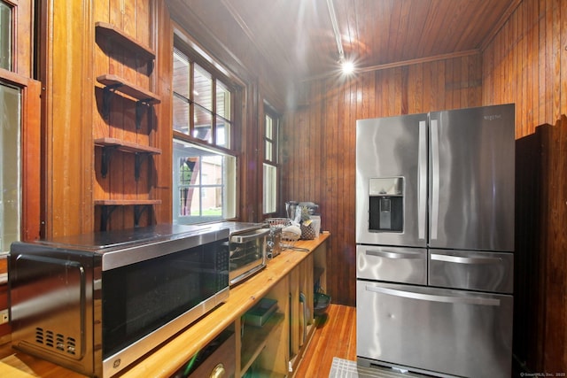 836 Prospect Ave, Hartford, CT 06105 - kitchen featuring stainless steel appliances, wooden walls, wood finished floors, wooden ceiling, and light countertops