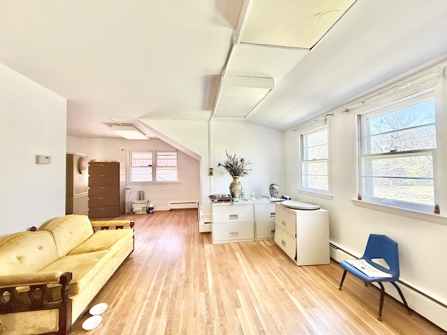 interior space featuring light wood-style floors, a baseboard heating unit, and a wealth of natural light
