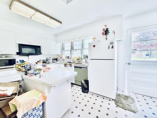 kitchen featuring black microwave, freestanding refrigerator, stainless steel microwave, dishwashing machine, and light floors