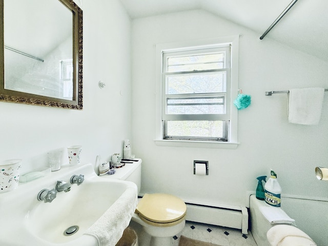 bathroom featuring a sink, toilet, tile patterned floors, lofted ceiling, and a baseboard heating unit
