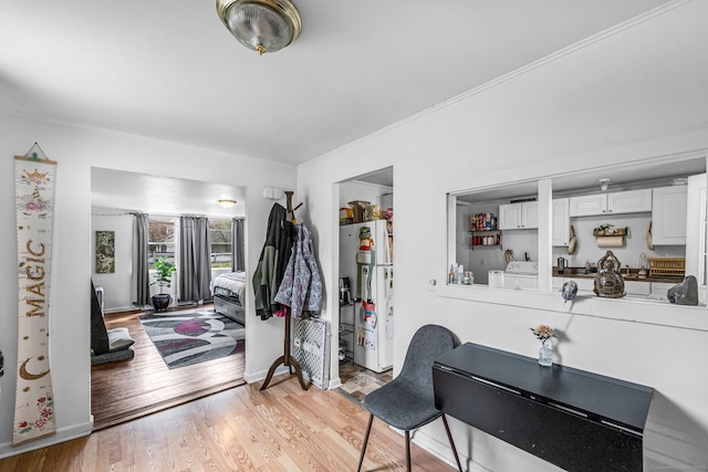 entrance foyer with light wood-style floors, baseboards, and washer and dryer