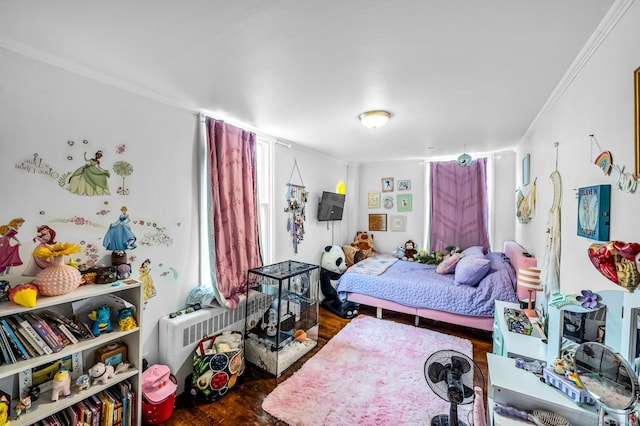 bedroom featuring crown molding and wood finished floors