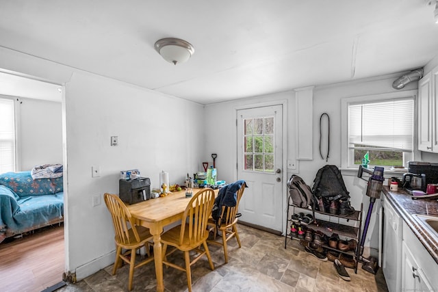 dining space featuring stone finish flooring