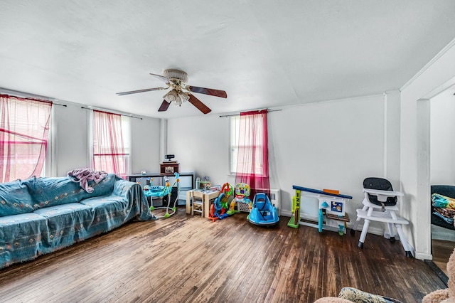 rec room with a ceiling fan, a healthy amount of sunlight, and wood finished floors