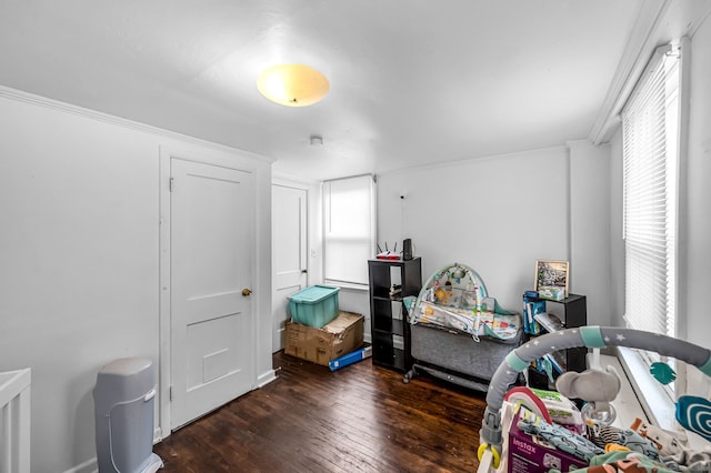 bedroom with baseboards, dark wood-style floors, and ornamental molding