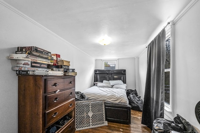 bedroom featuring ornamental molding and dark wood-style floors