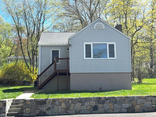 exterior space with a lawn and a chimney