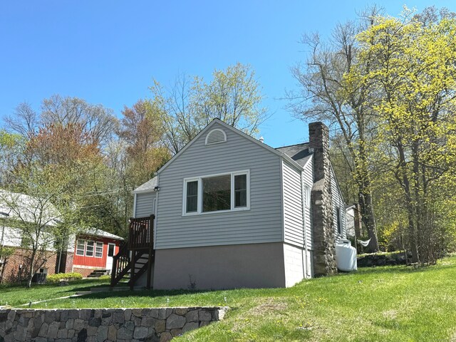 6 Fulton Dr, New Fairfield, CT 06812 - view of side of home featuring a yard, a chimney, and stairs