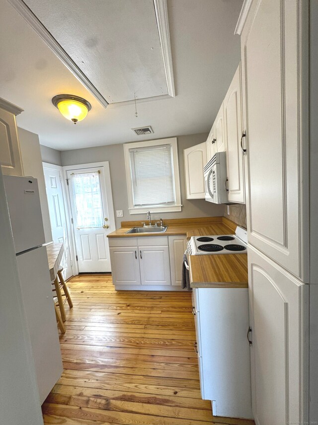 6 Fulton Dr, New Fairfield, CT 06812 - kitchen featuring visible vents, white appliances, light wood-type flooring, white cabinets, and a sink