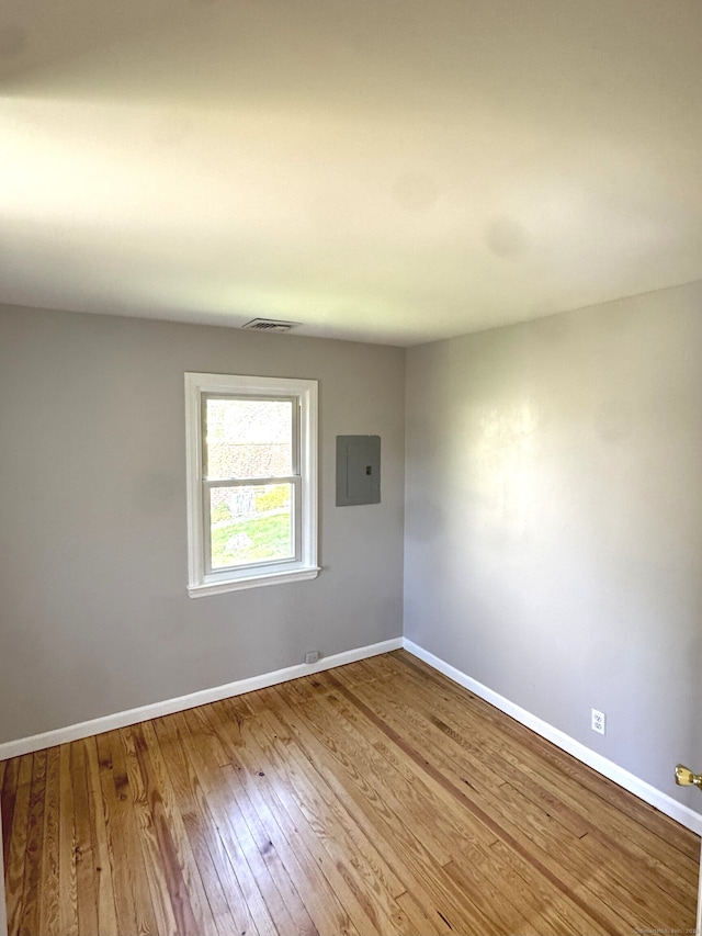 6 Fulton Dr, New Fairfield, CT 06812 - unfurnished room featuring baseboards, electric panel, hardwood / wood-style floors, and visible vents