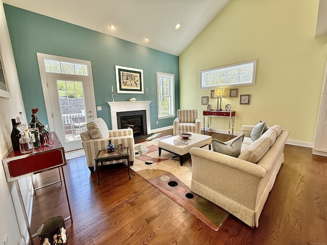 living area with a fireplace with flush hearth, high vaulted ceiling, baseboards, recessed lighting, and dark wood-type flooring