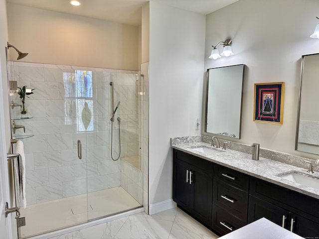 full bathroom featuring double vanity, a sink, marble finish floor, and a shower stall