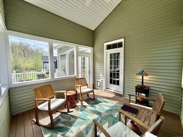 sunroom / solarium with high vaulted ceiling, wooden ceiling, and wood finished floors