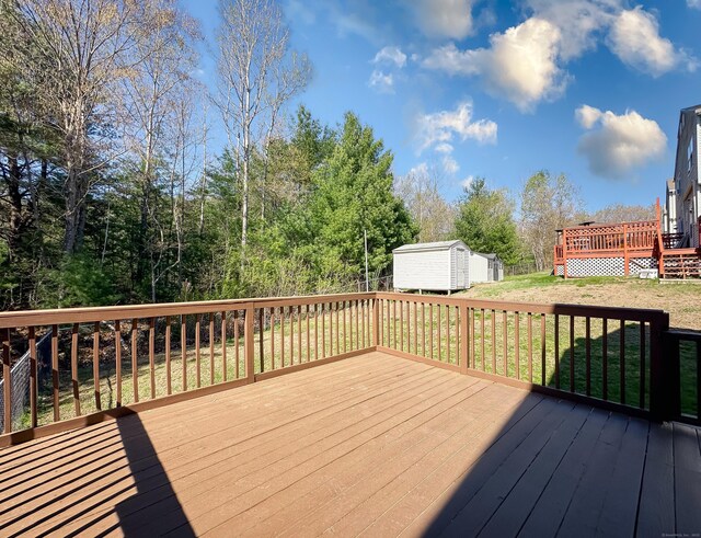 139 Downes St Unit 139, Waterbury, CT 06704 - wooden deck featuring an outdoor structure, a shed, and a yard