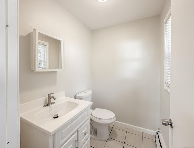 139 Downes St Unit 139, Waterbury, CT 06704 - half bathroom featuring vanity, toilet, tile patterned floors, baseboards, and a baseboard heating unit